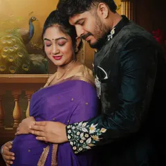 We celebrate love in all its forms, including the beauty of tradition. This couple's maternity portrait showcases a classic Indian style, with the mother-to-be in a beautiful purple saree and her partner in an embroidered jacket, creating a timeless and elegant memory.