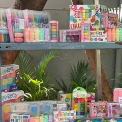 A shelf packed with colorful art supplies, from poster paints to chunky chalk. I make sure to have vendors that cater to all kinds of creative interests, helping you stock up on high-quality stationery.