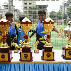 Eyes on the prize. Our young players admiring the trophies at the FANM Super Cup 2024, dreaming of the victory they've worked so hard for.