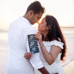The first hello. I specialize in creative and heartfelt announcement photos, like this sunset beach session in Mumbai. We can use ultrasound pictures, baby shoes, or other personal touches to share your exciting news with the world.