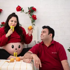 The joy of sharing treats. This shot captures the mother-to-be enjoying her mango drink while the father-to-be looks on with a smile. It's a sweet, candid moment.