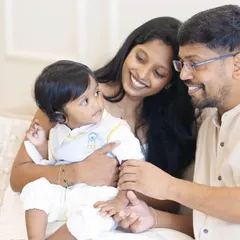 A tender moment between parents and their baby during his first birthday shoot. The studio's soft lighting is perfect for capturing these gentle, intimate family connections.
