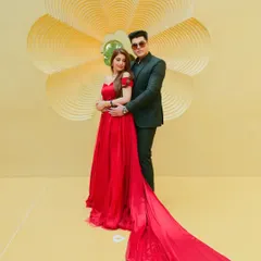 A glamorous pre-wedding portrait featuring a bold red gown with a dramatic train. We work with couples to create high-fashion looks that feel both modern and romantic, set against minimalist backdrops.