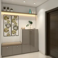 A simple and elegant entryway unit with a seating bench and a closed shoe cabinet. The backlit shelf and metallic wall art add a touch of sophistication.