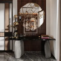 A detail shot of the console table in the Dadar project. The combination of a stone base, black marble top, and sculptural mirror creates a stunning and artistic focal point.