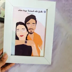 A hand holds a 5x7 inch white frame showcasing a custom digital portrait of a couple. The caption "when hope turned into faith" adds a personal touch to this sentimental piece.