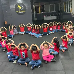 The kids' batch making heart signs with their hands, a gesture we love to share. It's our way of spreading the love and positivity that dance brings into our lives.