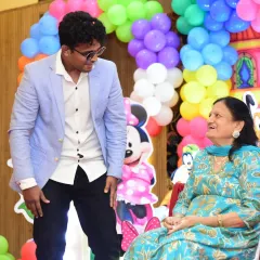 It's important to me that every single guest feels seen and included. I enjoy sharing a laugh and creating special moments with guests of all ages, like this one with a family elder.