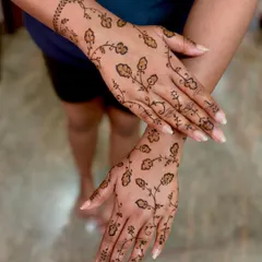 A delicate and unique design with floral vines scattered across the back of the hands, perfect for a reception or party.