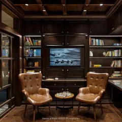 The library in 'Mina Nivas' was designed to feel like a moody, opulent English den. It features Chesterfield-style chairs, a waffle ceiling, and extensive book-dotted walls, creating a quiet and contemplative retreat for work or reading.