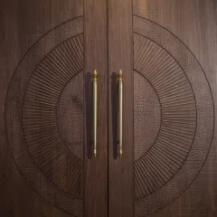 A close-up of a custom main door, where I've combined different textures like sunburst fluting and faux crocodile skin. The brass handles add a final touch of classic elegance.