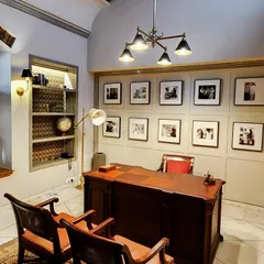 This home office, designed for a renovated bungalow in the Lutyens Delhi area, is a study in functional elegance. We created a gallery wall to celebrate the client's personal journey, paired with classic wooden furniture and carefully selected lighting to build a sophisticated and inspiring work ambiance.