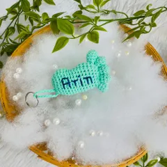 The mint green baby foot keychain with the name 'Arin' embroidered on it.