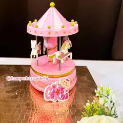 The charming pink musical carousel is a standout piece that makes this hamper a magical keepsake.