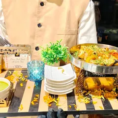 This image shows our 'Cheese Steak Toast with Garlic Juse' being served on an elegant tray by our professional staff. It highlights our focus on not just the food, but also the style and sophistication of the service.