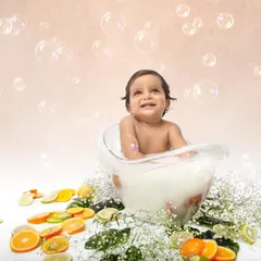 A milk bath session is a unique and fun way to celebrate a first birthday. Surrounded by bubbles and citrus slices, this little one's happy expression is absolutely priceless.