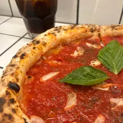A close-up of our Marinara pizza with an iced coke. The vibrant red of the tomato sauce is just beautiful.