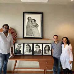 It is always a pleasure to see my art find its home. Here I am with my clients, who commissioned a series of family portraits. Seeing their satisfaction with the final collection is the most rewarding part of my work.