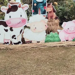 Adorable, life-sized cutouts of farm animals, including a cow, sheep, pig, and horse. These were placed on hay to create a playful and interactive scene for the kids.