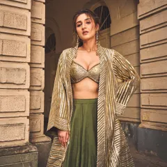 A full view of this modern lehenga set, showing how the longline jacket adds drama and sophistication. The combination of a metallic bralette, flowing skirt, and sharp jacket is my signature approach to contemporary Indian fashion.