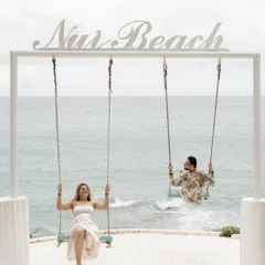 A playful and iconic shot at Nui Beach in Phuket. This image captures the fun and carefree spirit of a destination pre-wedding shoot.