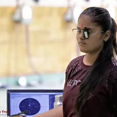 The intense focus of a competitor just before her shot. You can see the electronic target in the background, which I use to provide instant and accurate scoring, just like in official ISSF world events.