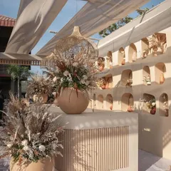 The bar area from the Desert Oasis event, featuring a custom built counter with fluted details and a backdrop of arched niches, all filled with dried flowers and earthy pottery.