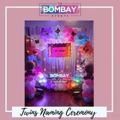 Double the joy! A beautiful butterfly-themed naming ceremony decoration for twins, featuring a colorful balloon arch and two baby foil balloons.
