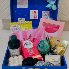 Inside the bride's trunk. We packed it with a "Team Bride" sash, Body Shop shower gel, a "Boss Babe" frame, and other pampering items to help her relax and celebrate.