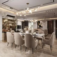 An opulent dining area in a Lucknow residence, complete with a built-in bar cabinet. The marble-topped table, plush velvet chairs, and modern chandeliers create a perfect environment for formal entertaining.