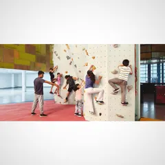 Our kids bouldering sessions are all about fun, safe exploration. A coach guides a group of young climbers on a beginner friendly wall, helping them learn basic climbing techniques, build confidence, and work together in a playful environment.