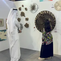 A beautiful moment of connection. Here, a visitor in traditional attire is taking a closer look at the intricate textures of my large-scale nautilus sculpture.