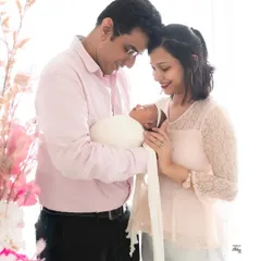 A quiet, tender moment between new parents as they gaze at their baby. These are the unscripted interactions that become your most cherished memories.