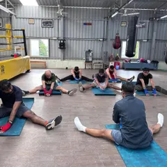 We work on flexibility after every class. This seated forward bend helps to stretch the hamstrings and lower back, areas that get tight from the explosive movements in boxing.