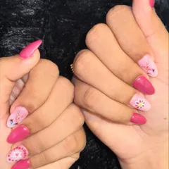 Get ready for Garba with these Navratri-inspired nails. This festive set features a vibrant pink base with intricate, traditional patterns hand-painted in white.