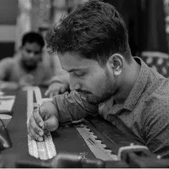 The focused dedication of one of my skilled craftsmen, carefully applying details that will make a garment truly special.