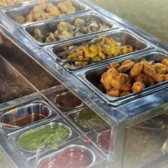 Our starter station offers a fantastic variety of fried appetizers, complete with an assortment of our signature chutneys and dips. There's a perfect bite for everyone to begin the feast.
