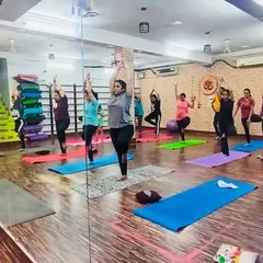 A wide view of our yoga session in progress. You can see the supportive environment where everyone works at their own pace.
