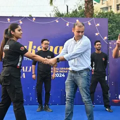 Our female instructor demonstrates a wrist-grab escape to a participant during a live workshop. We believe in hands-on, interactive training.