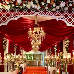 Color and texture can completely transform a space. I used rich red velvet drapes and magnificent crystal chandeliers to create this dramatic and royal entrance aisle, ensuring a grand and memorable welcome for every guest.
