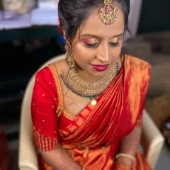 A close up of Sowmya's beautiful bridal makeup. The warm, shimmery eyeshadow and bold lip colour are perfect for her red saree.