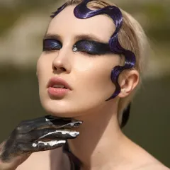 This is from my 'Siren of the Sea' concept. I sculpted the hair into a wet, wave-like pattern using a strong-hold gel and created a deep, shimmery purple smokey eye. The single rhinestone accent adds a touch of ethereal magic to this dark, fantasy makeup look.