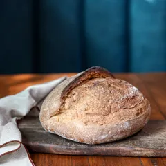 Our classic sourdough loaf, sitting pretty. Baked fresh daily, it has a wonderfully tangy flavor, a chewy, open crumb, and that perfect crust. It’s the foundation for our sandwiches and toasts, and you can take a loaf home from our deli.