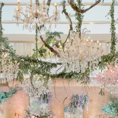 A stunning installation of crystal chandeliers in pastel pink and blue, intertwined with natural branches and greenery. This created a magical, enchanted forest ceiling for the Sangeet night.