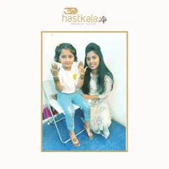 An image from my feature, where I'm applying mehendi to a little girl. I believe in making everyone, no matter their age, feel special with my art.