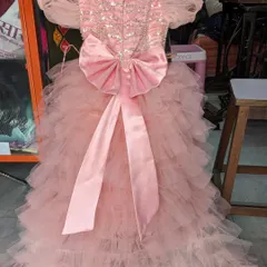A custom-ordered baby girl's birthday frock with ruffle layers and a big bow at the back. I can create the dream dress for your little one's special day.