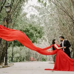 Create your own movie moment with our pre-wedding photoshoot gowns. This dramatic red gown with a long, flowing trail is designed to make a statement and give you breathtaking photos you'll cherish forever.