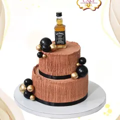 This two-tiered Jack Daniel's themed cake is perfect for celebrating a milestone with style. It features a rich chocolate texture, sophisticated black and gold accents, and is topped with a miniature bottle for a personalized touch.