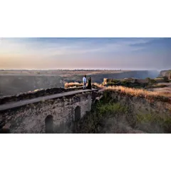 A couple shares a quiet moment on an old stone bridge during their pre-wedding shoot. Using the drone allows me to capture both the intimacy and the epic scale of the landscape.