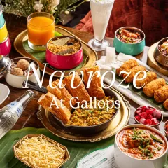 A festive Parsi feast for Navroze at Gallops. This wide shot captures an entire table spread, including classic dishes like Salli Boti and Patra Ni Machi, creating an image of abundance and celebration.
